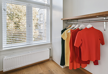 Stanford closet with bright wardrobe and aluminum window blinds